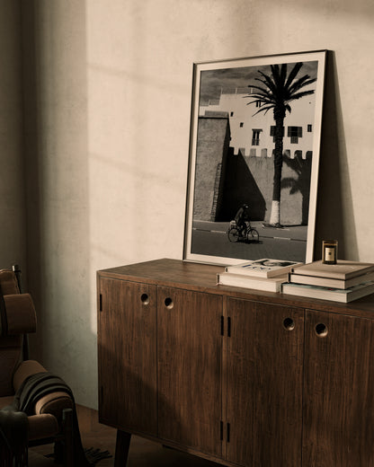 A Man on a Bicycle in Morocco, with a Palm Tree and traditional architecture - Black & White Photography Print A1 A2 A3 - Explura.co