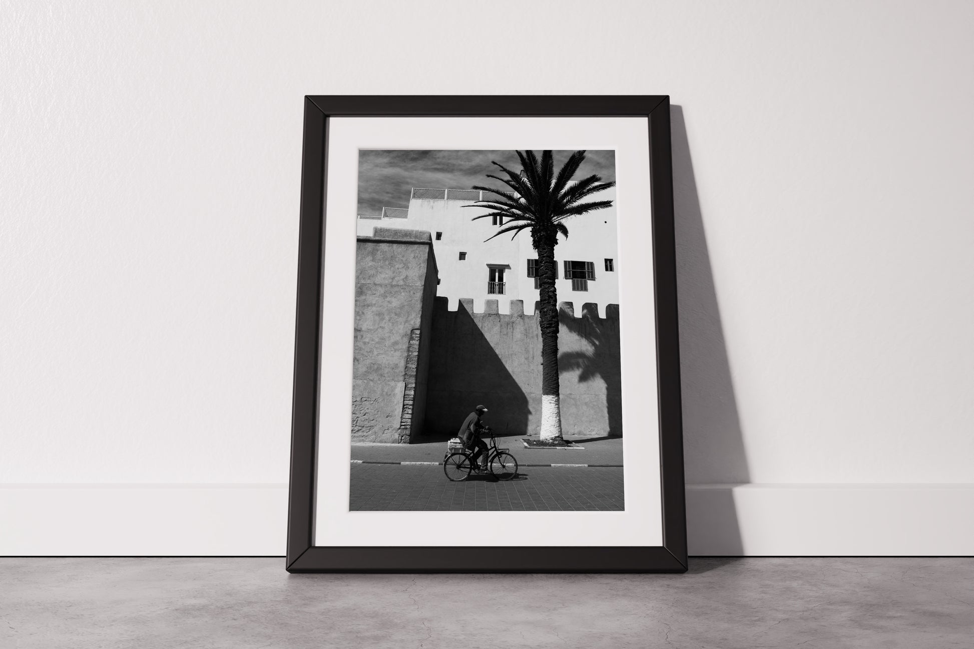 A Man on a Bicycle in Morocco, with a Palm Tree and traditional architecture - Black & White Photography Print A1 A2 A3 - Explura.co
